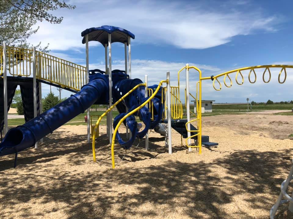 A vibrant playground featuring a blue slide, inviting children to play and explore in a cheerful outdoor setting.