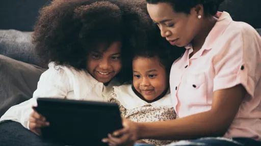 Teacher and a studetns looking into an ipad