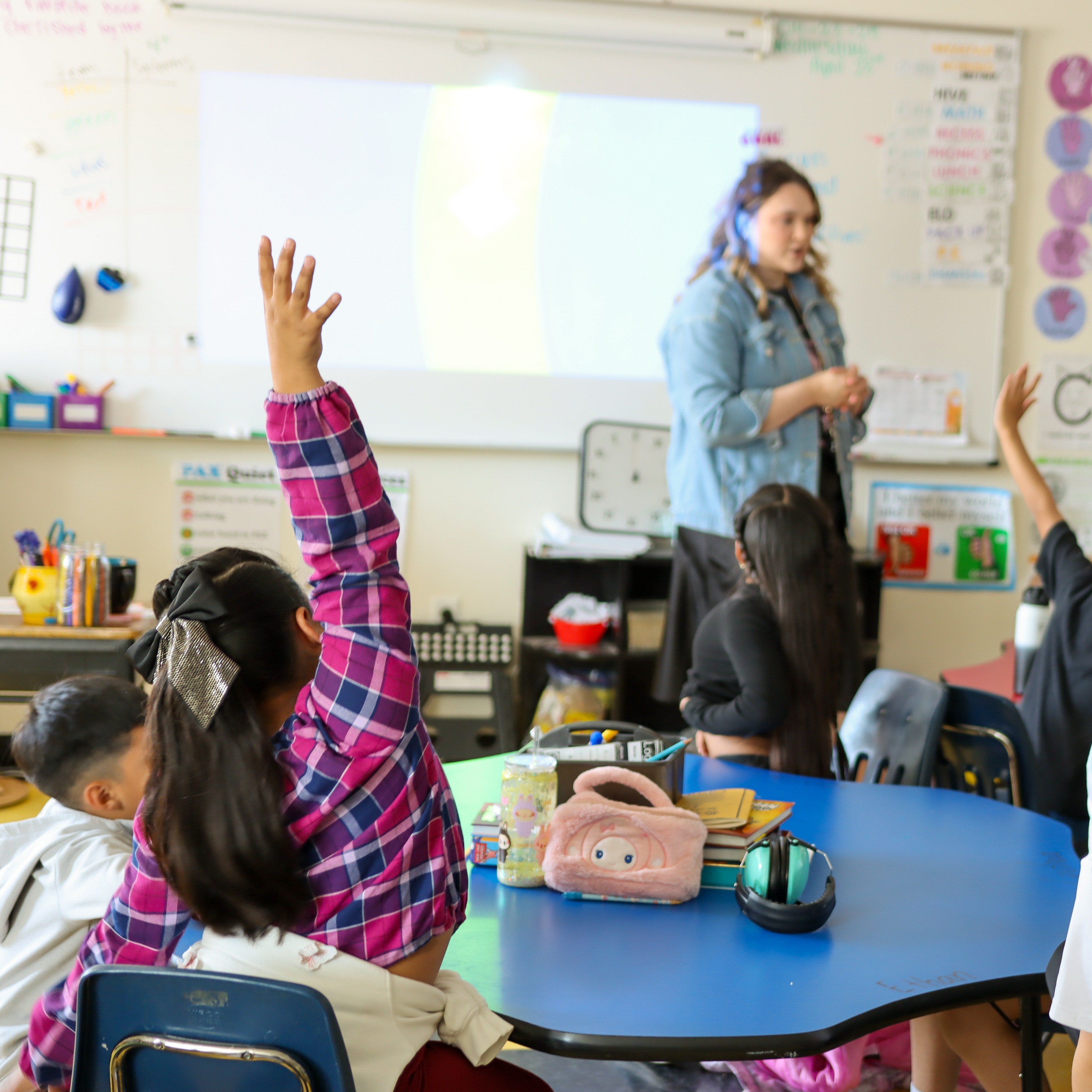 teacher instructing elementary students