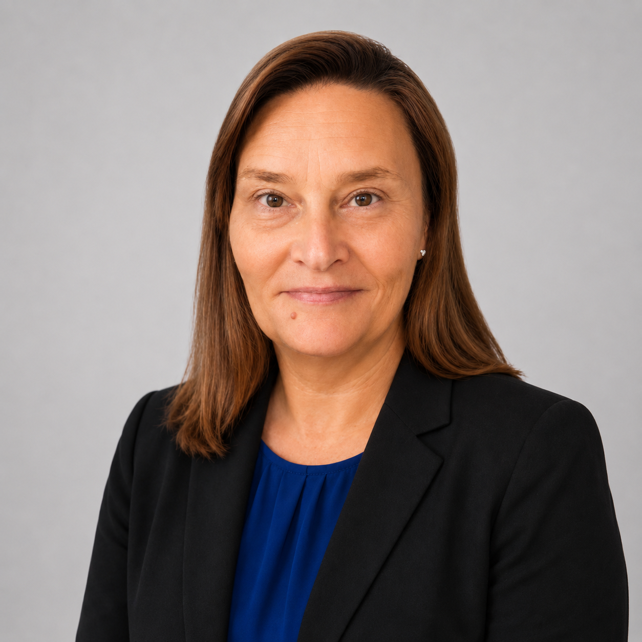 Tabitha Hite: Professional portrait of a woman wearing a black blazer over a royal blue blouse.