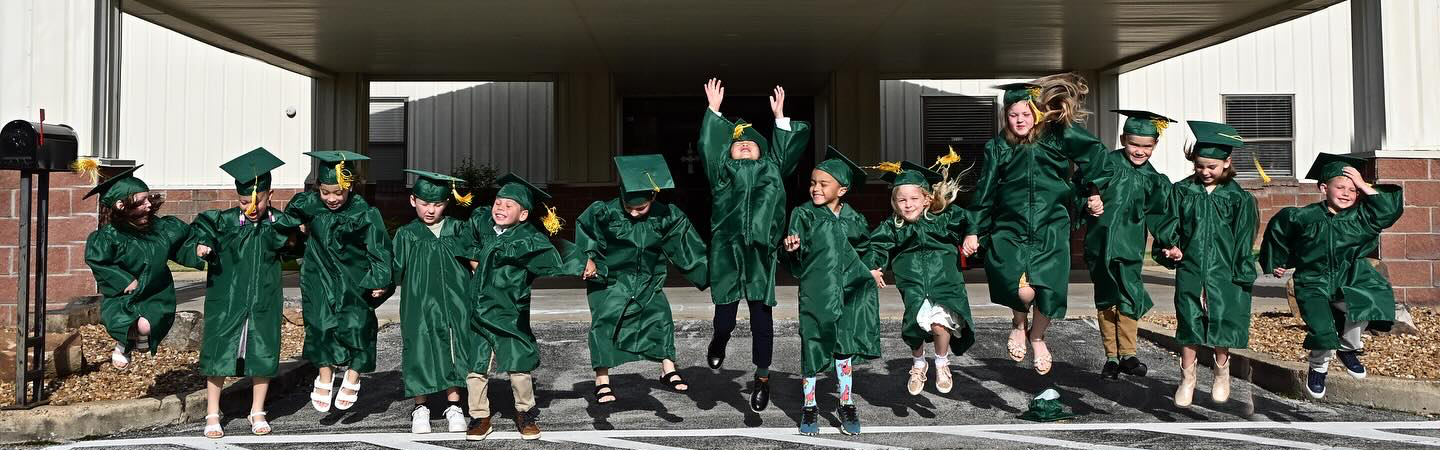 Kindergarten graduates jumping 