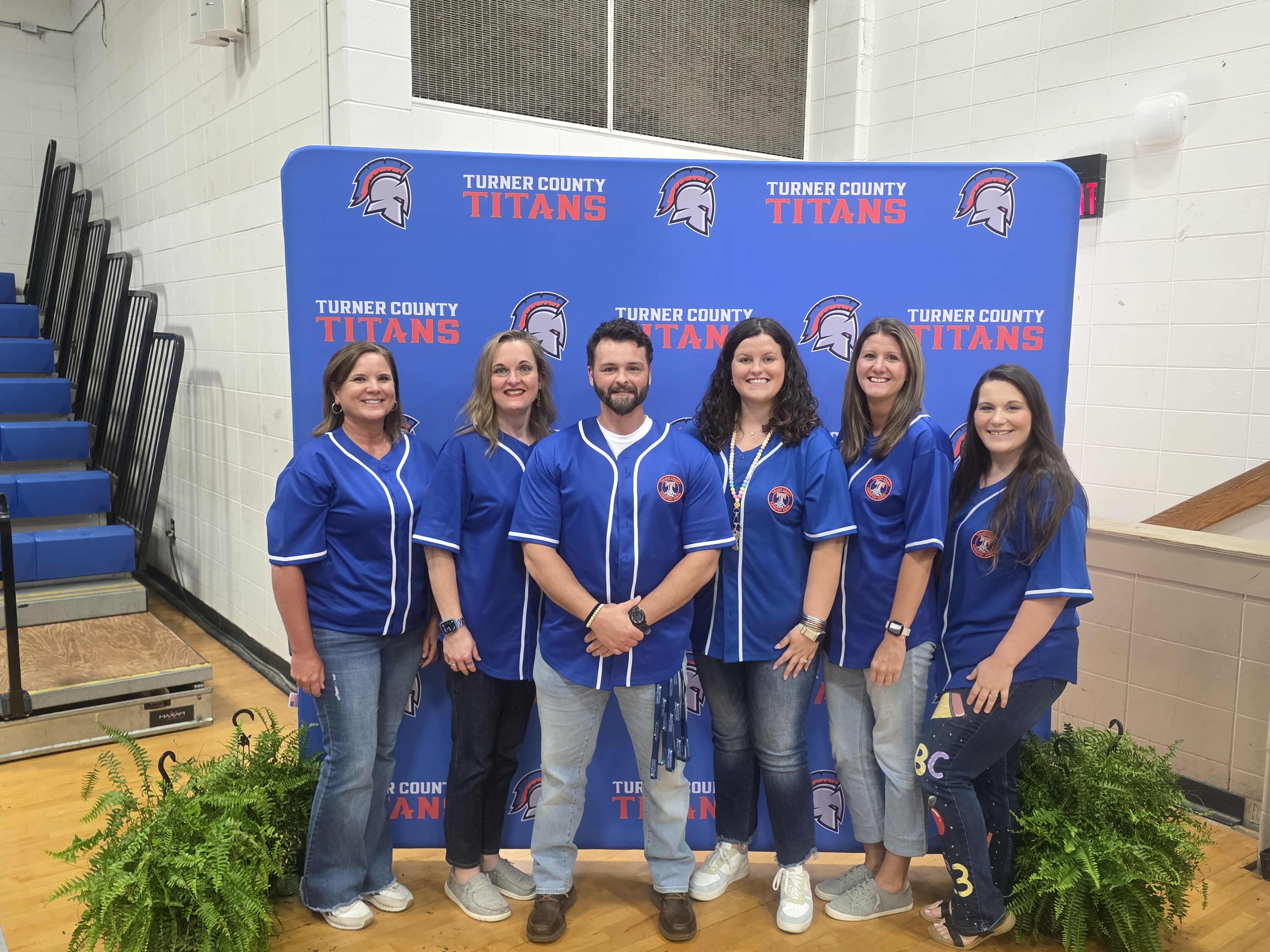 adults, backdrop with titan logo