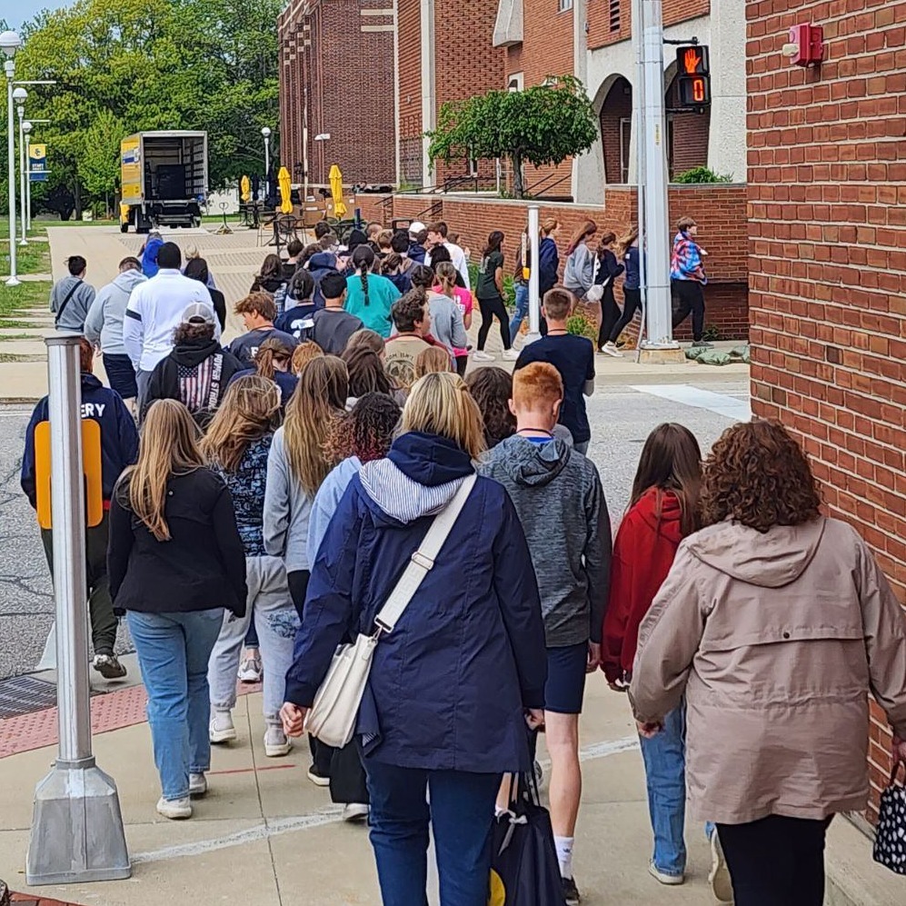 A group of students and chaperones walk on the SC4 campus during the annual 8th grade tours