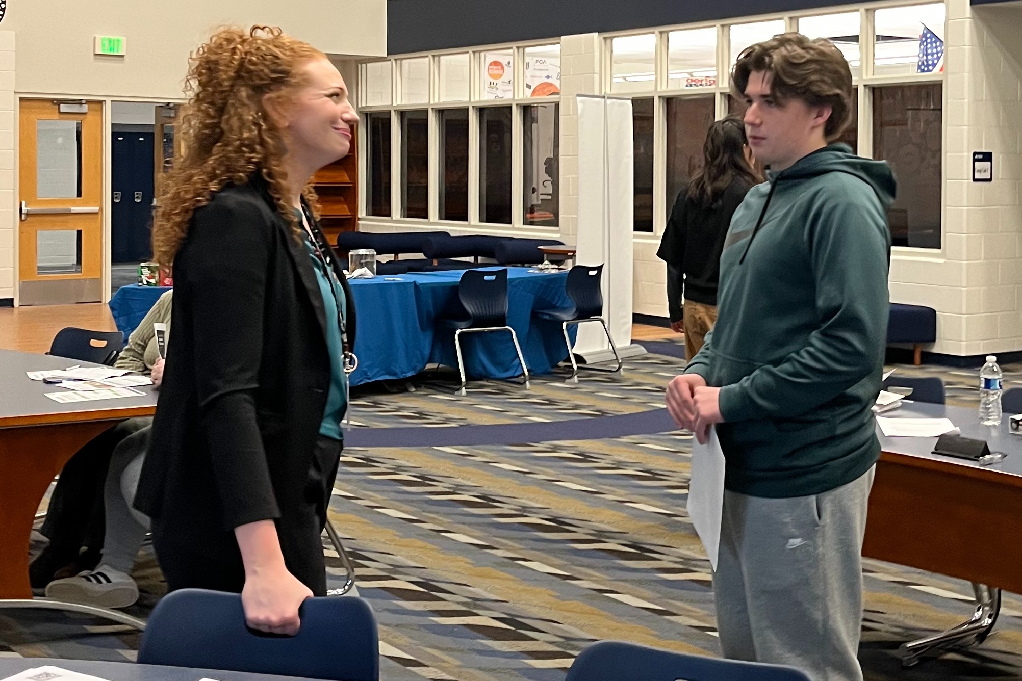 BWCAN Supervisor Erin Schweihofer talks with a student during a FAFSA night event at Marysville High School