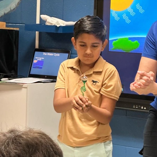 Little boy doing science project