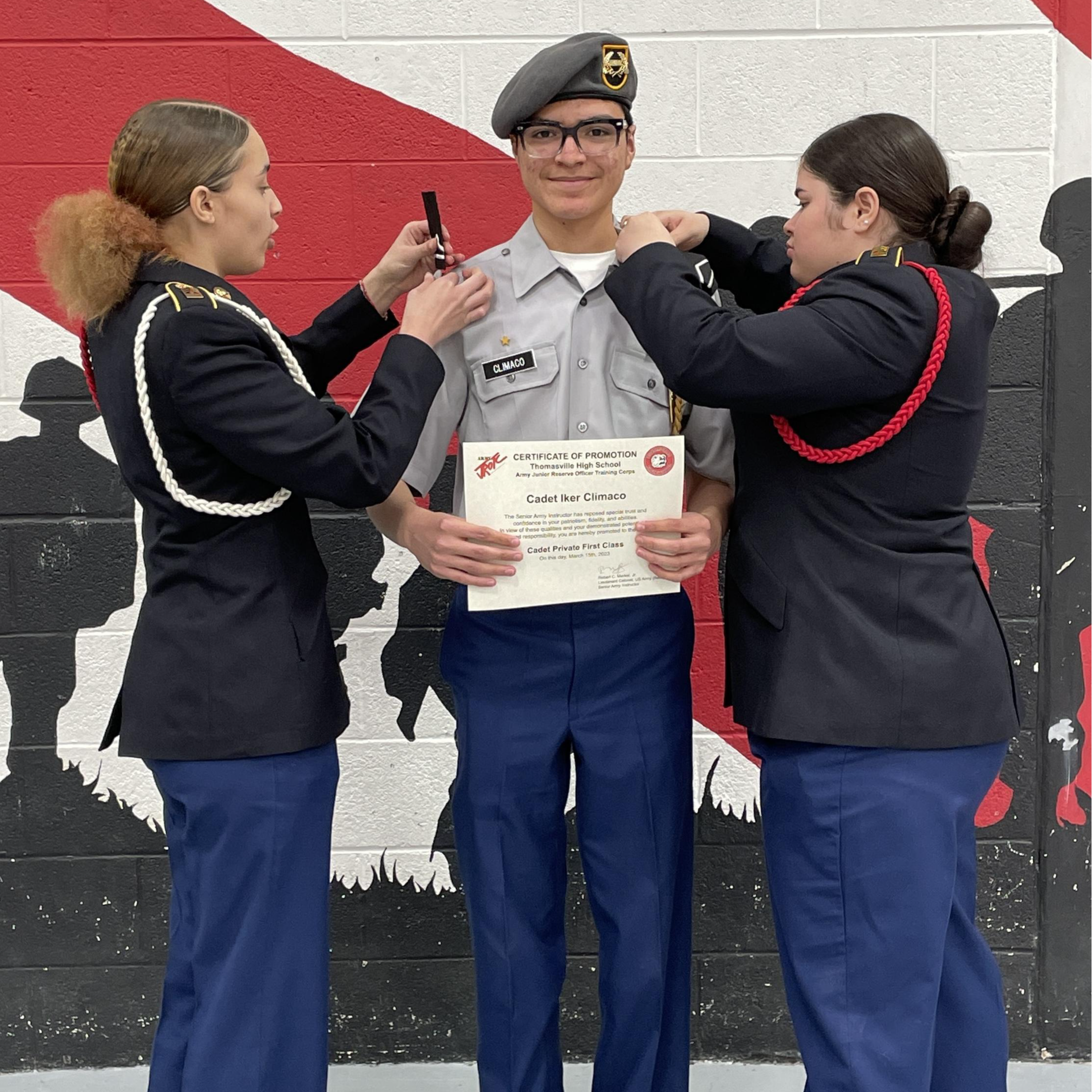 A woman in uniform proudly holds a certificate, showcasing her achievement and dedication to her profession.