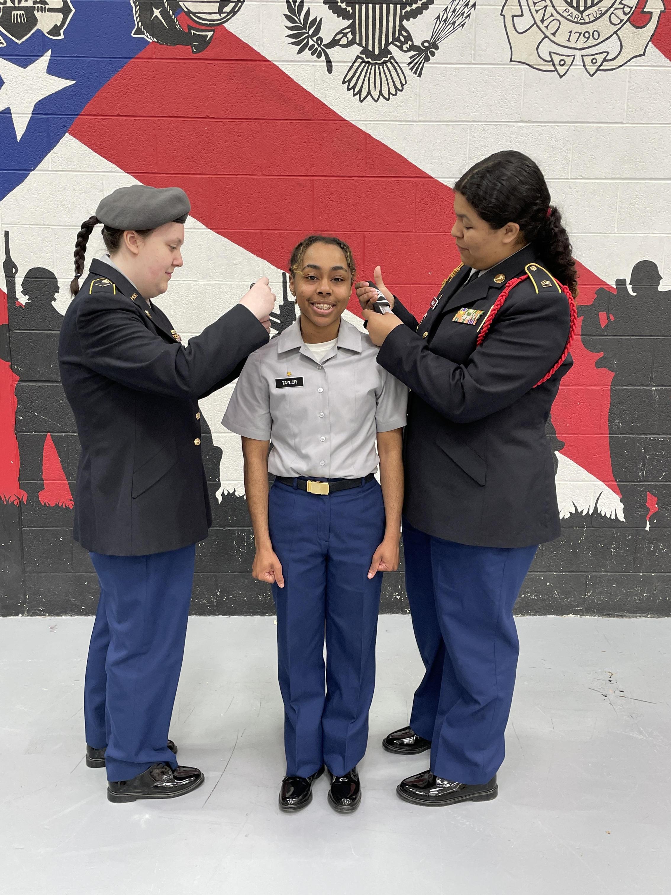 Three women in uniform stand side by side, showcasing camaraderie and professionalism in their attire.