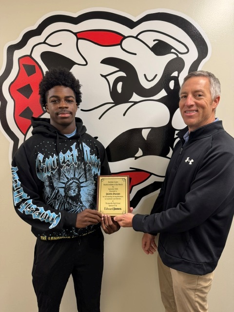 Quintin Brunson receives Athlete of the month from Edwards Jones employee
