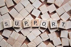 Support spelled out in wooden blocks, showcasing a tactile and educational representation of the concept.