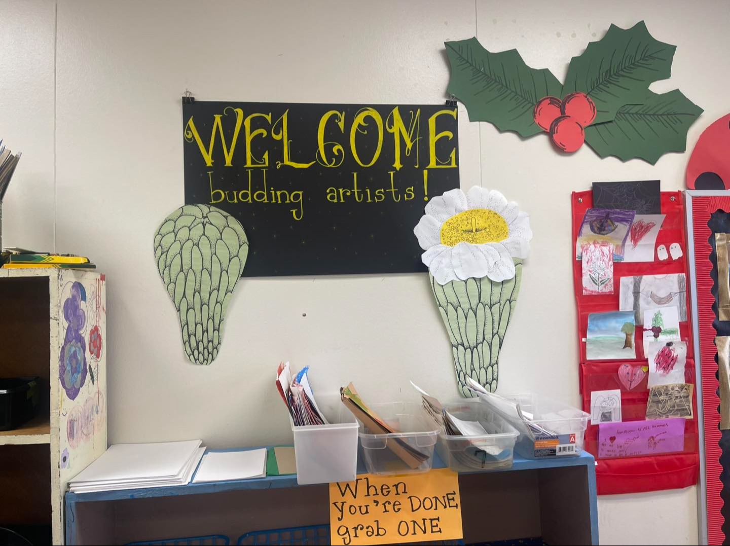 Poster on a wall that says, "Welcome budding artists!"