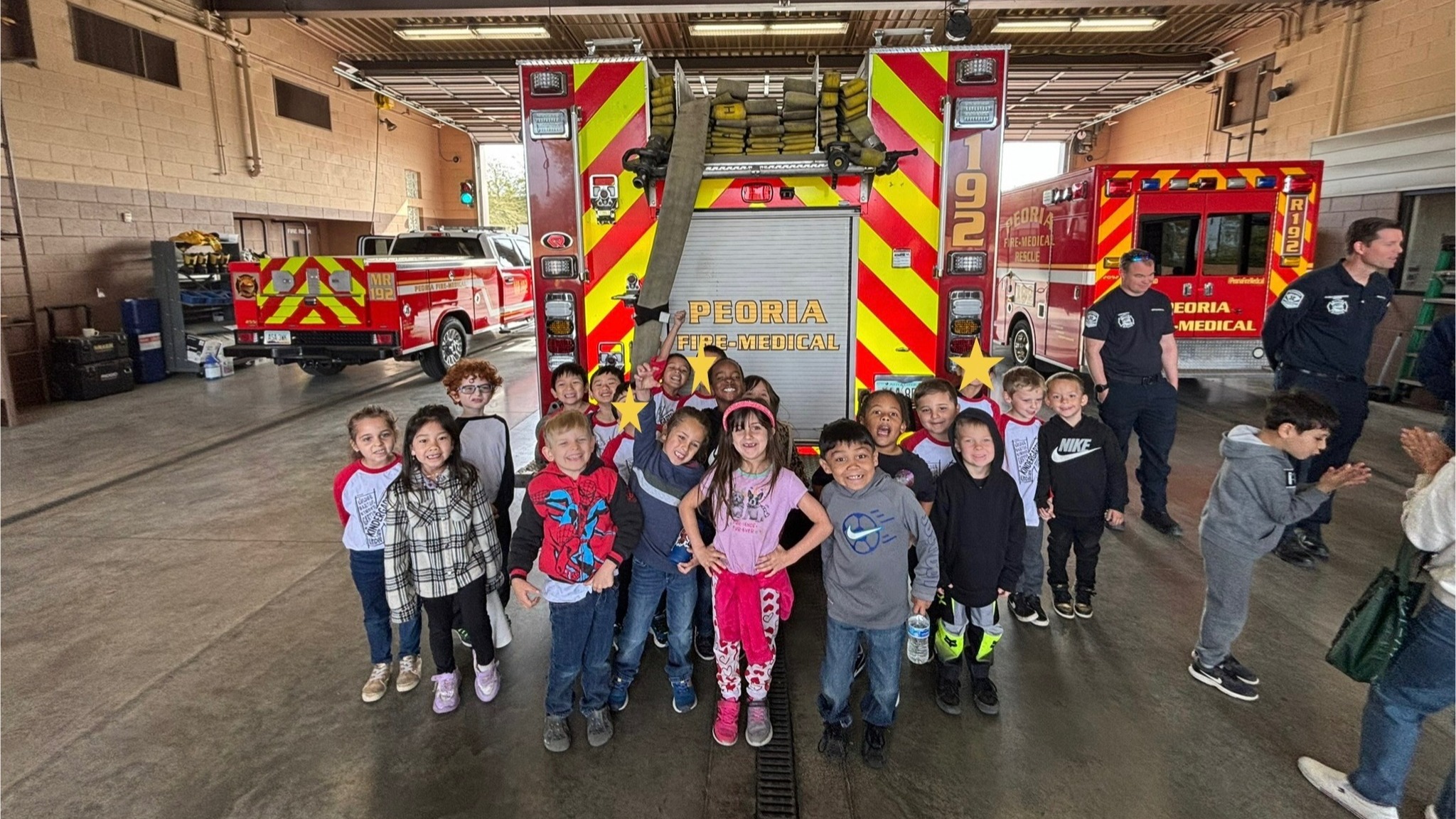 Students pictured behind a fire truck from Peoria Fire-Medical