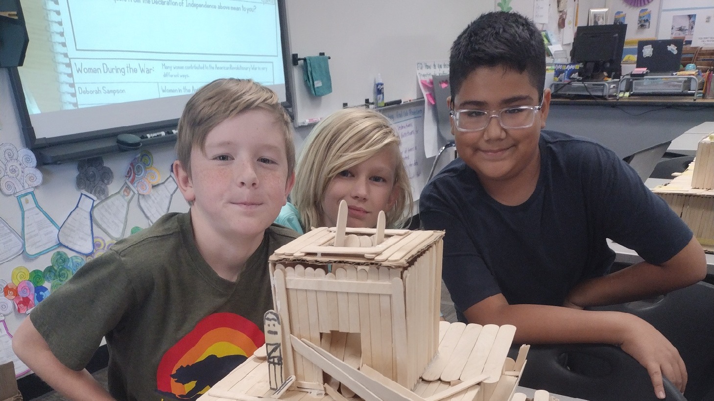 Students building a tower with popsicle sticks