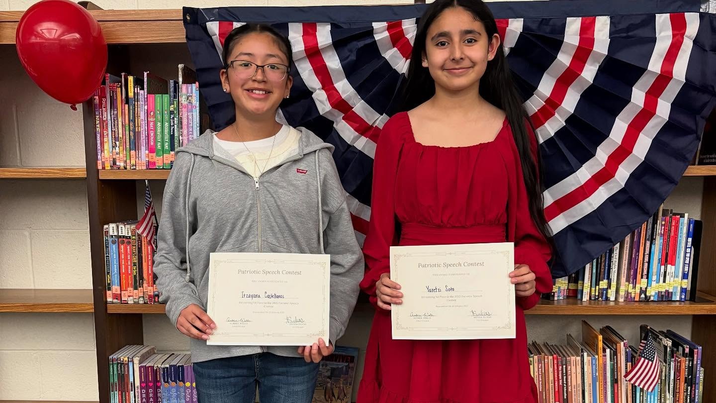 Two Patriotic Speech Contest students holding up certificates