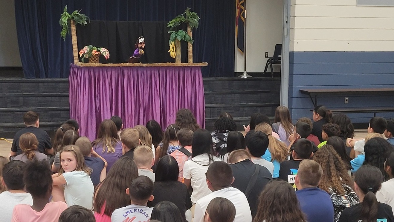 students at Cotton Boll enjoying a puppet show
