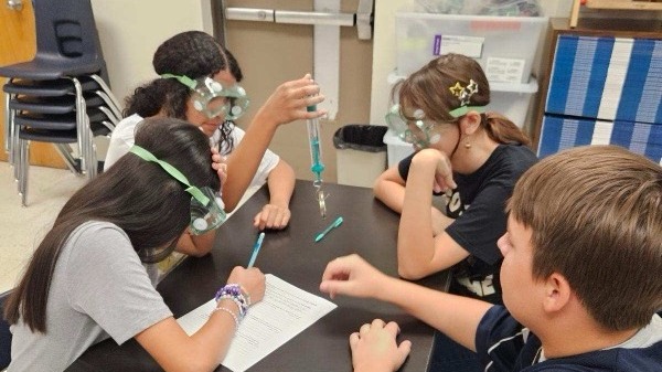 STUDENTS SITTING IN A CLASSROOM