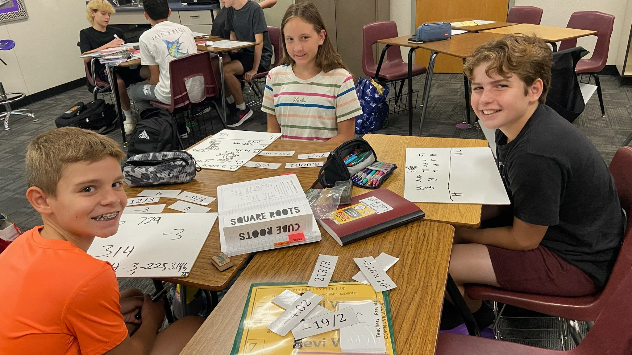 Students smiling while working on math