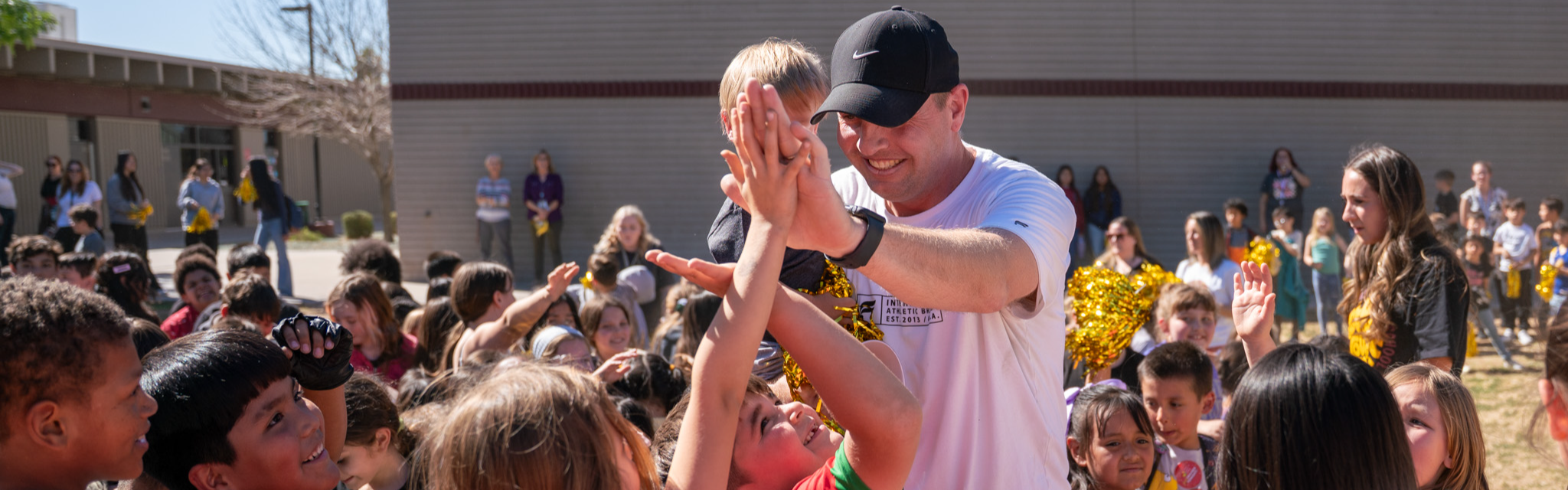 Teacher high-fiving students