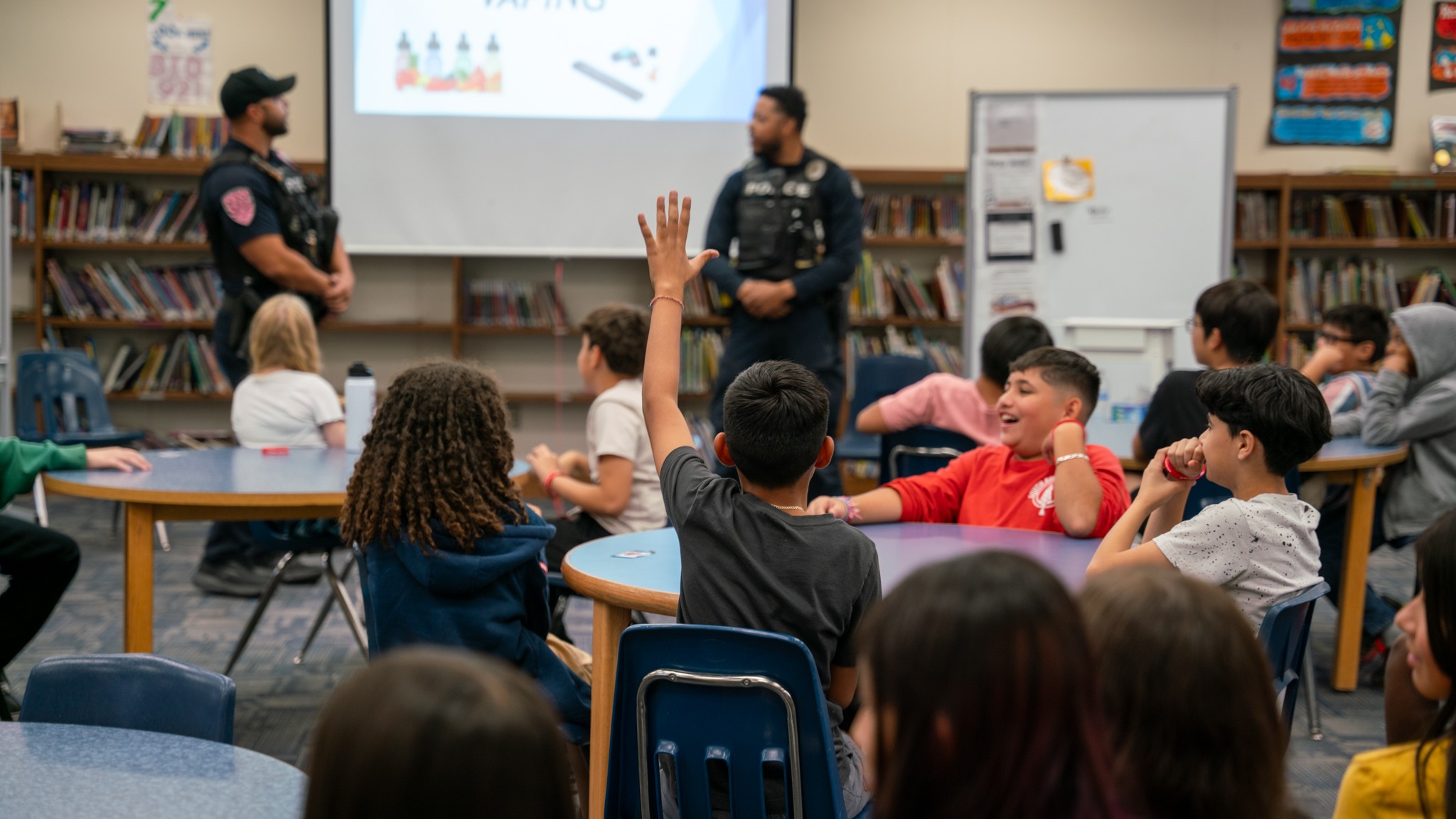 Police officers presenting on vaping to students