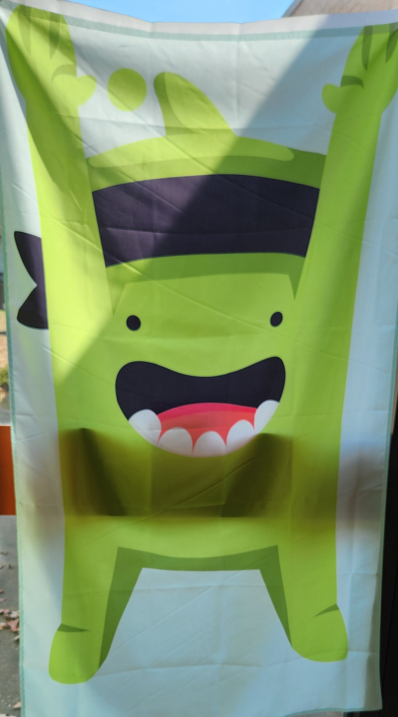 Class Dojo mascot - mojo - banner hanging in the main hallway of SES
