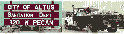 A sign for the City of Altus Sanitation Department, displaying the address 320 W. Pecan, alongside an image of a sanitation truck loaded with debris.