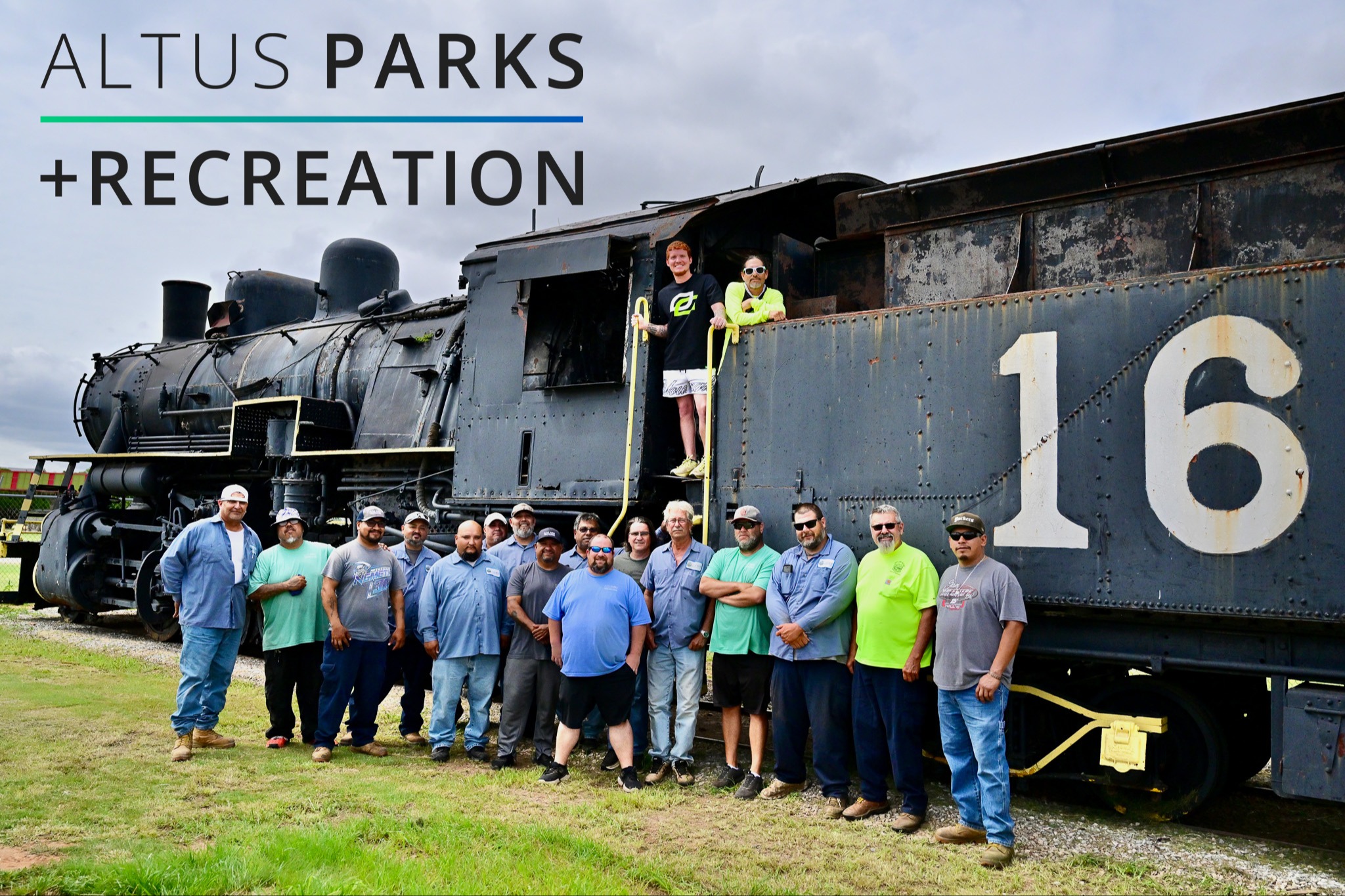 Group of Parks and Rec department smiling for a photo taken on the side of a train.