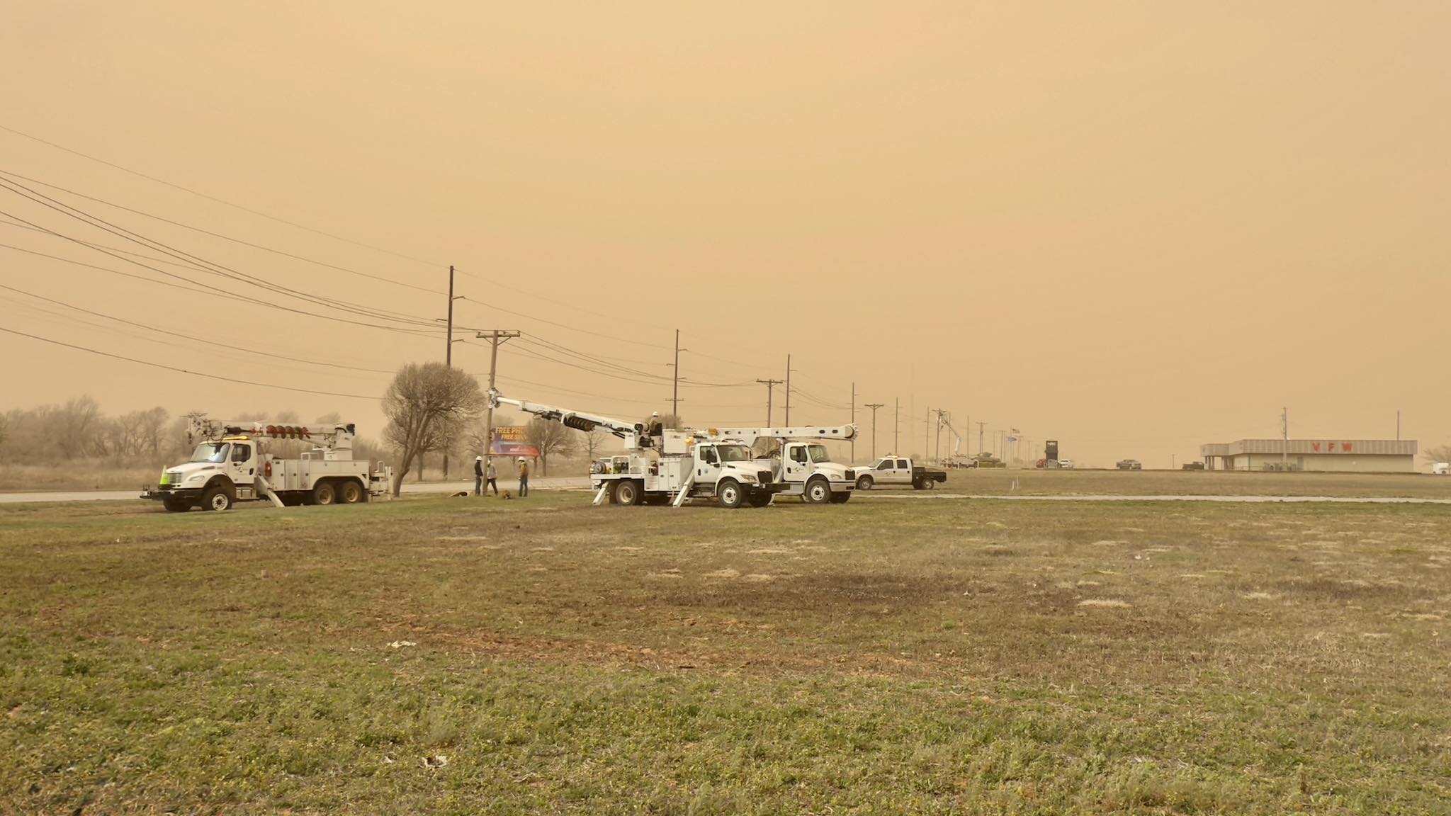 Altus Power Crew working on powerlines during a dust and sand storm