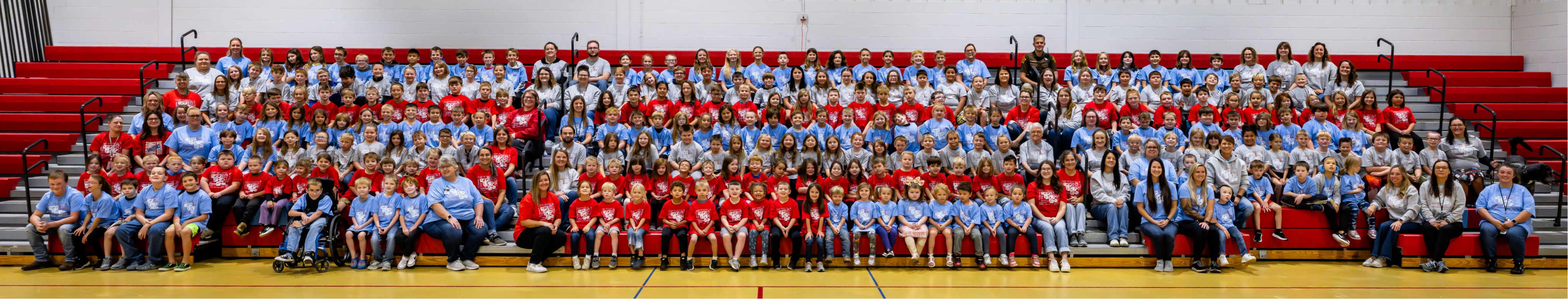 students sitting in the gym
