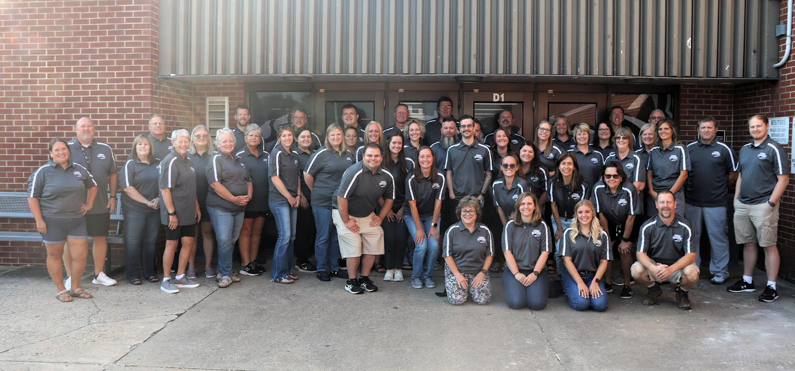 three rows of staff members