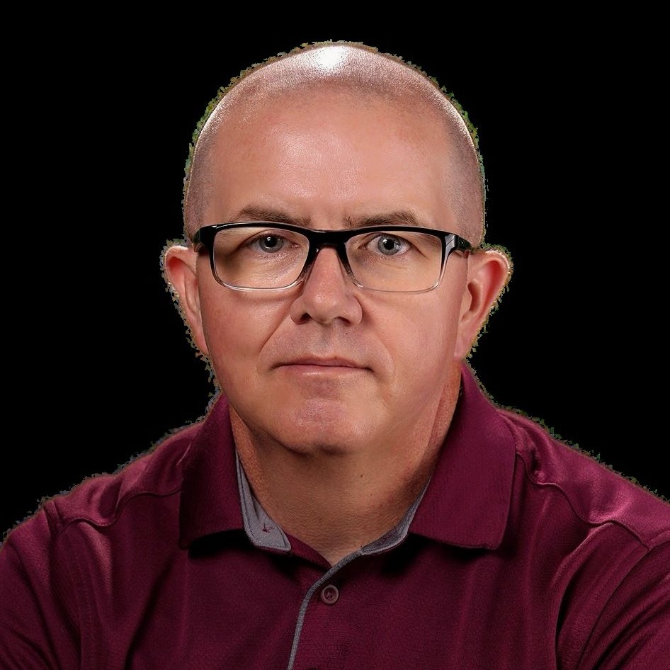 A man with no hair and glasses
