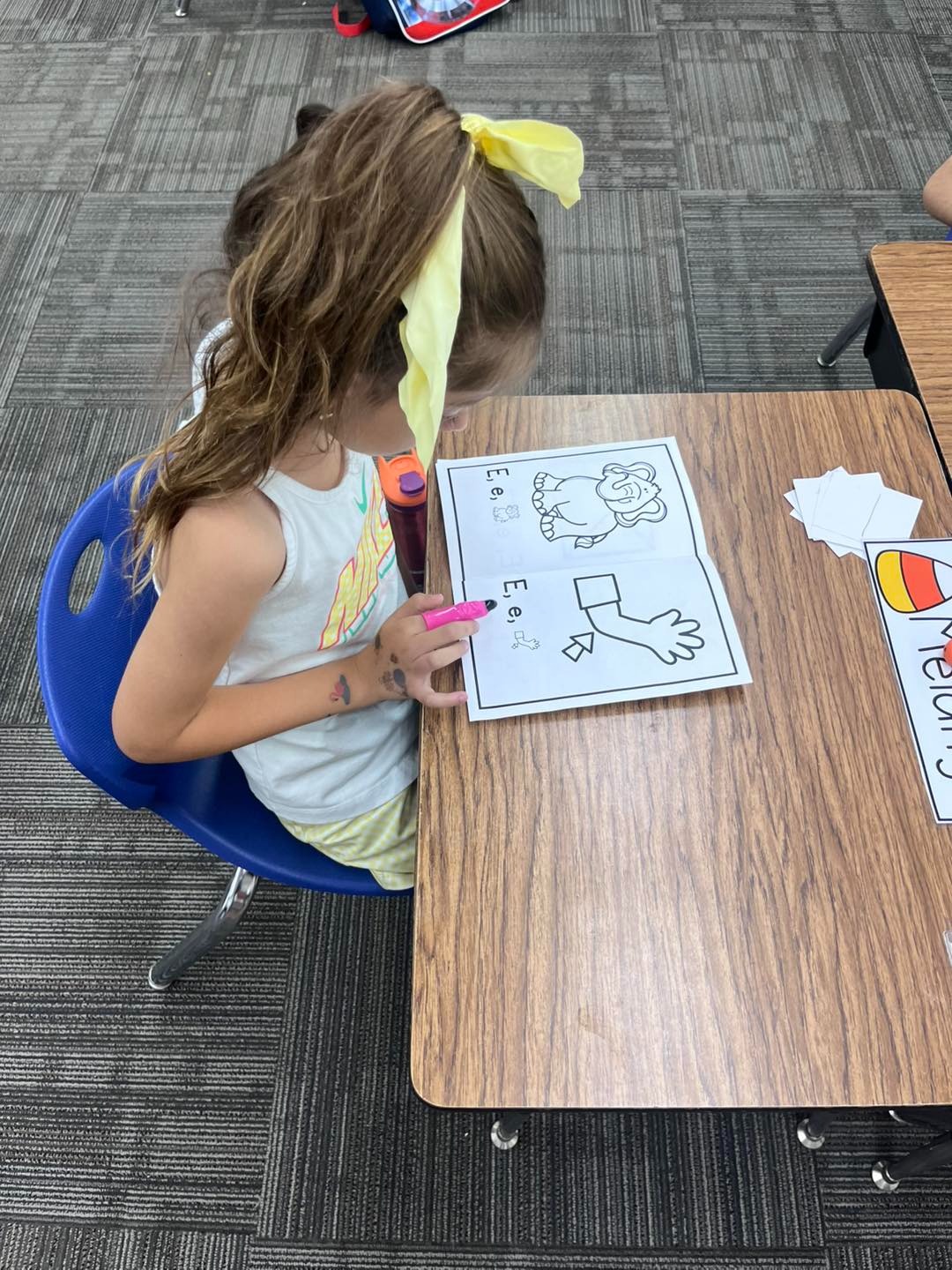 Student working on a coloring sheet