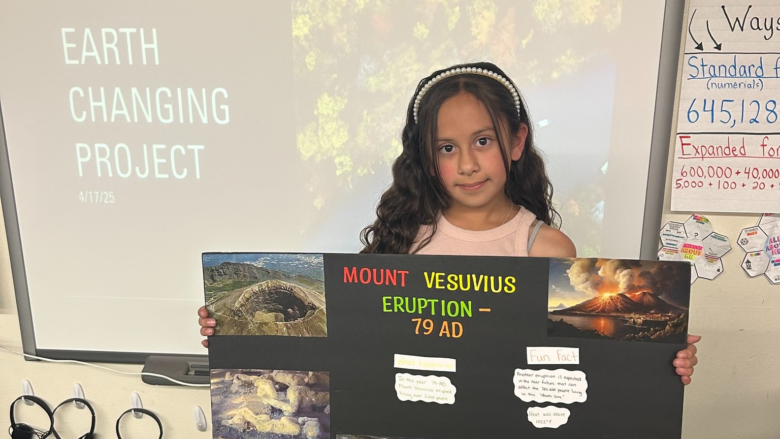 Student holding up science project