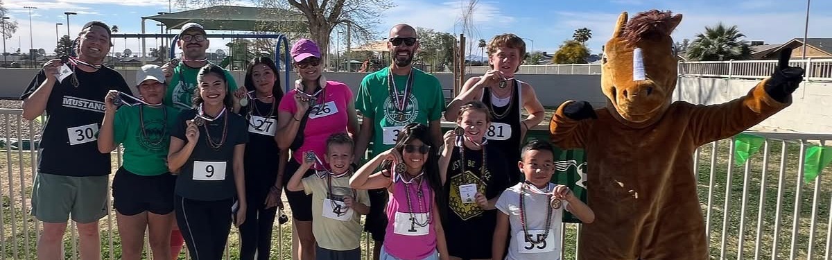 Group of students, staff, and families who won medals during our 5k event