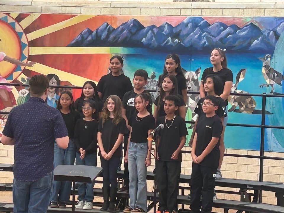 Students singing on risers during the Arts Festival