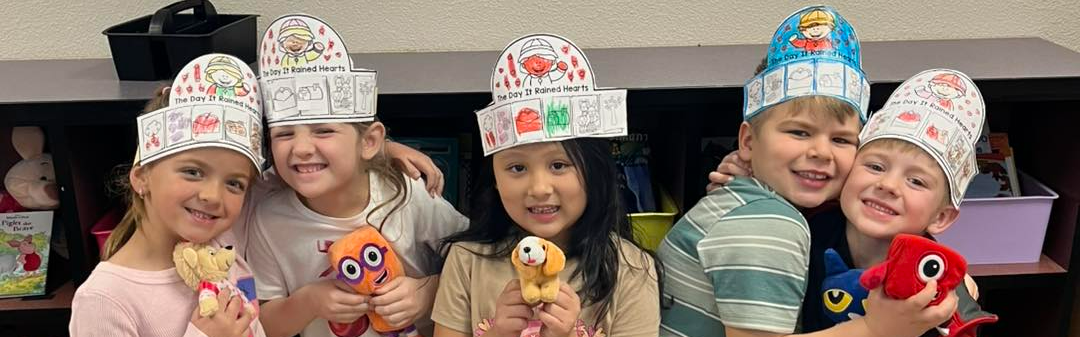 Picture of our kindergarteners holding up a craft