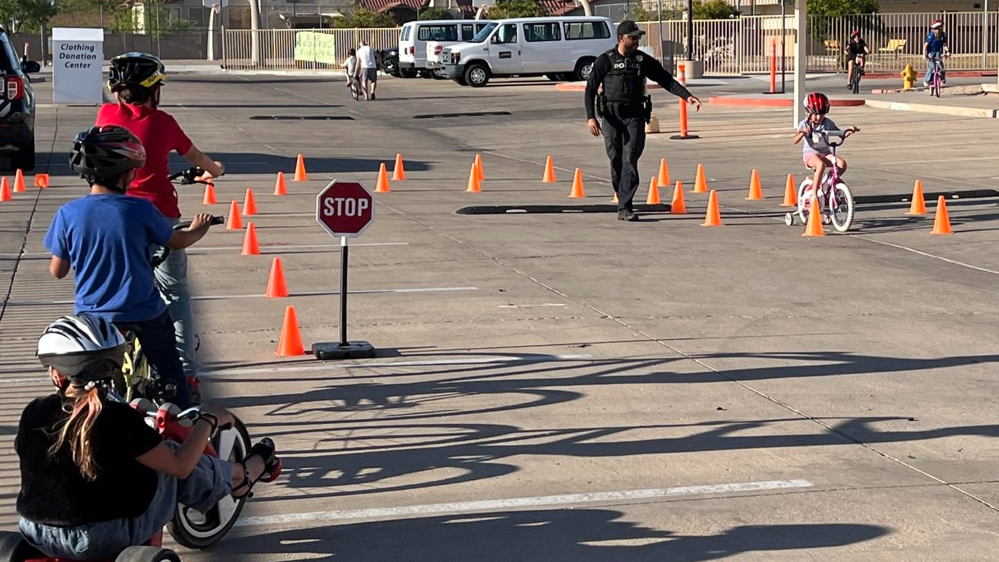 Police officer assisting students in the school parking lot
