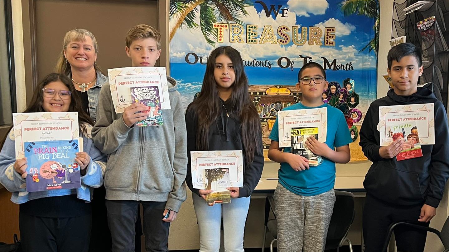 Students holding up perfect attendance certificates