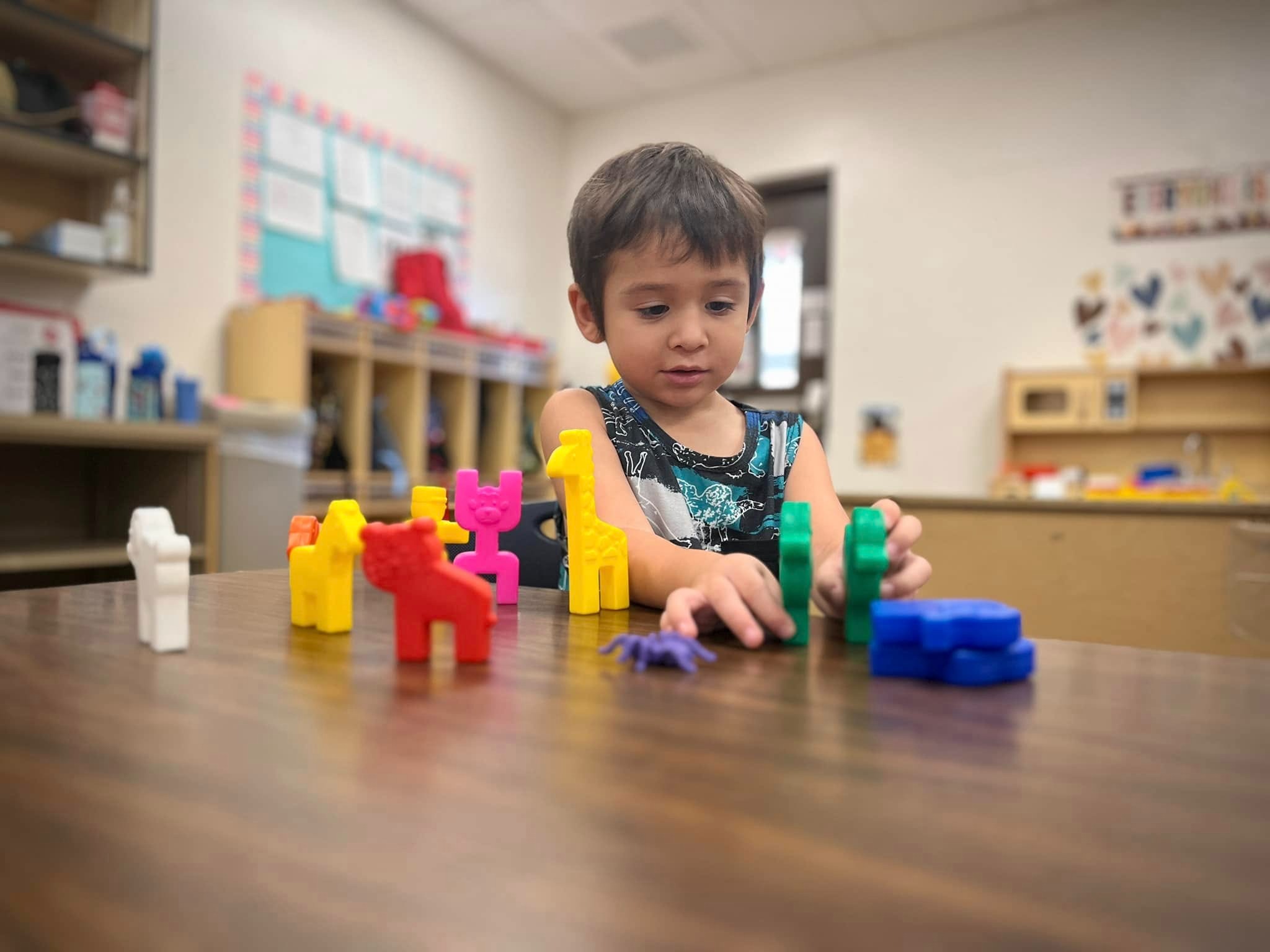 Preschooler playing with toys on desk