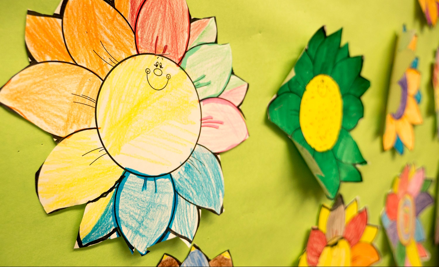 Picture of artwork hanging up on a bulletin board  with cutouts of sunflowers