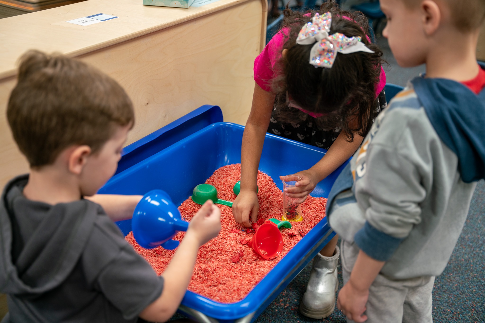 Kids playing in a bin full of toys
