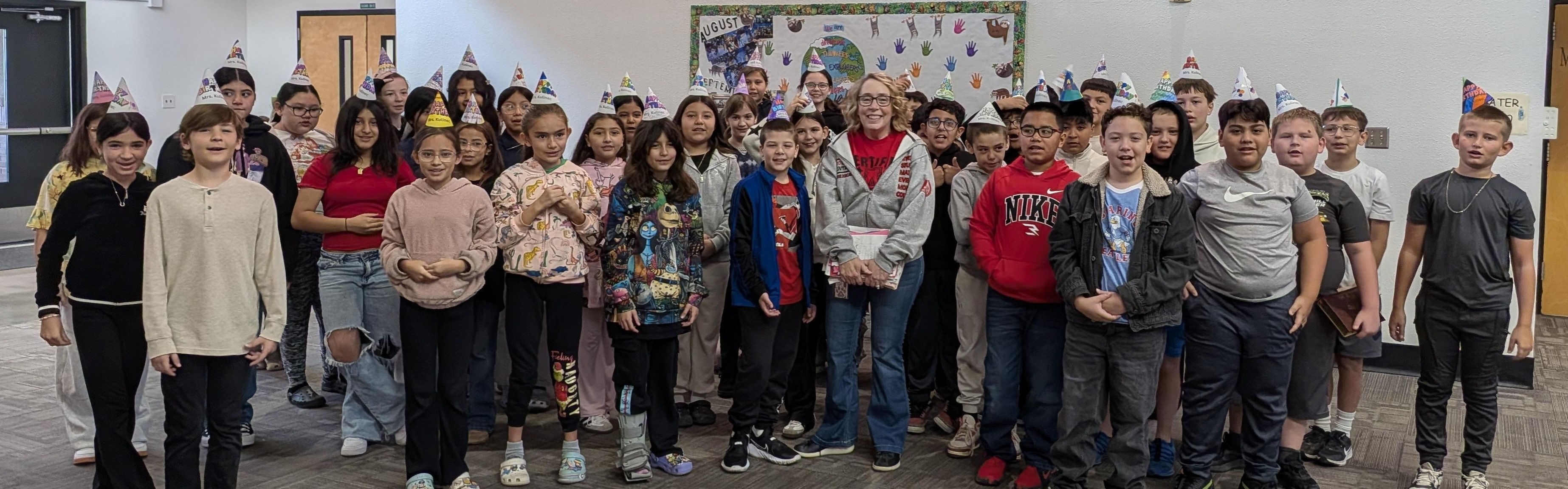 Students celebrating principal's birthday with her