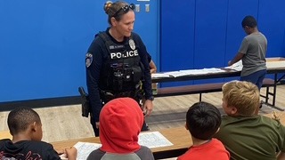 Pic of Peoria Police Officer speaking to kids