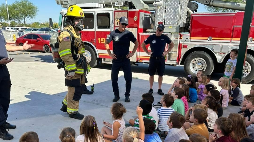 Students listening to presentation from fire department
