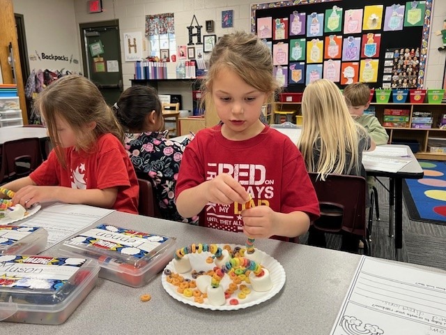 Kindergarten students working with cereal