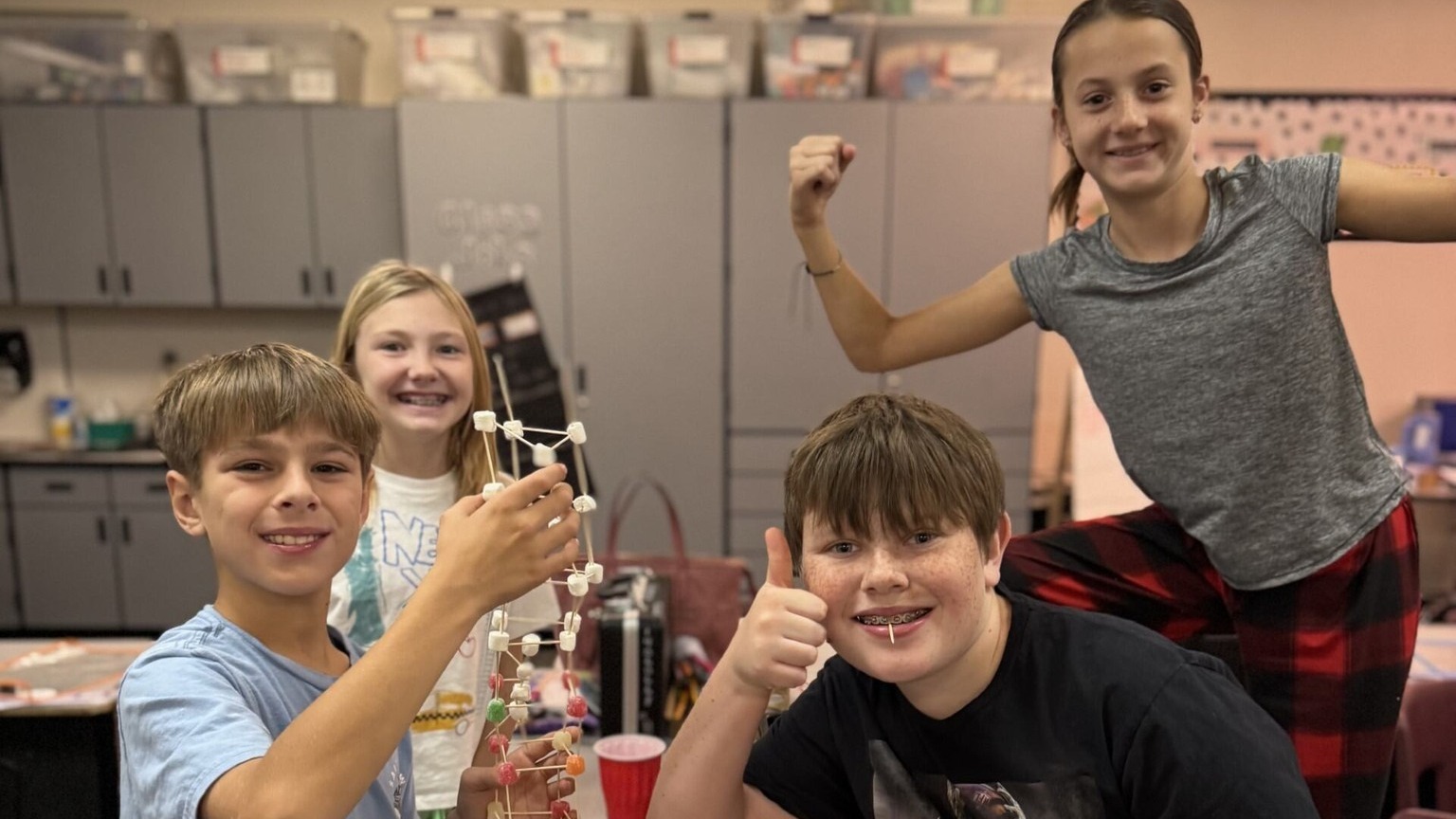 Students holding up their marshmallow toothpick project