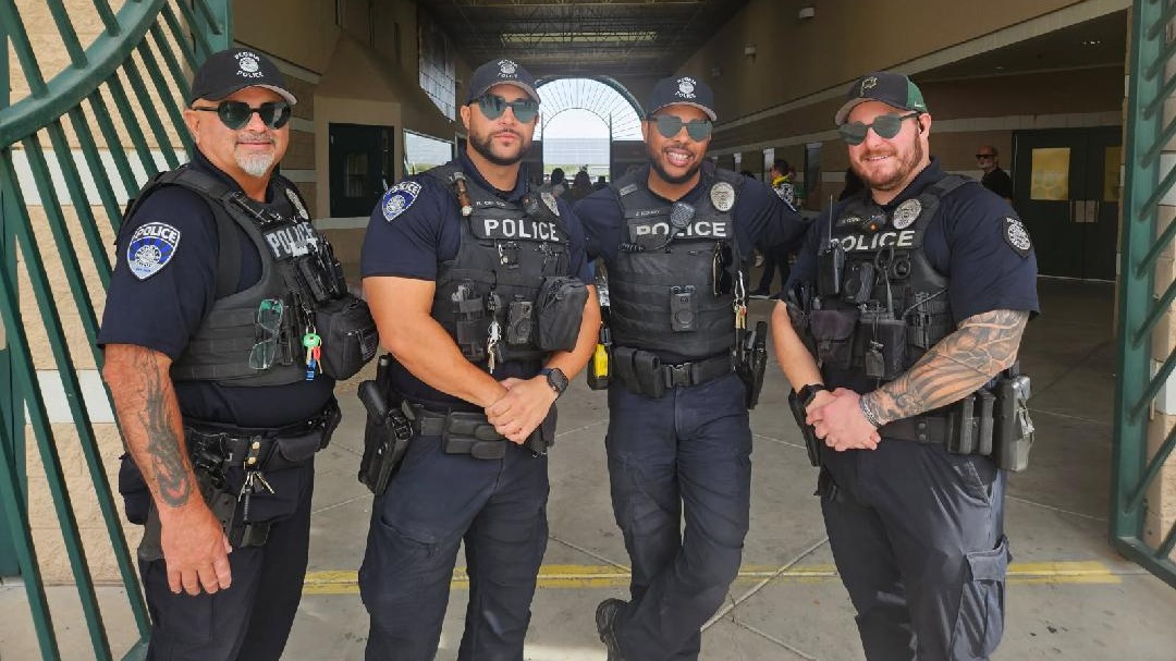 Four Peoria Police Officers standing in the PHS archway