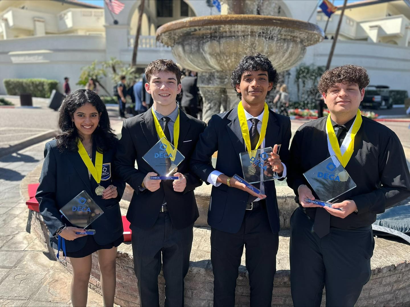 DECA students posing with their trophies