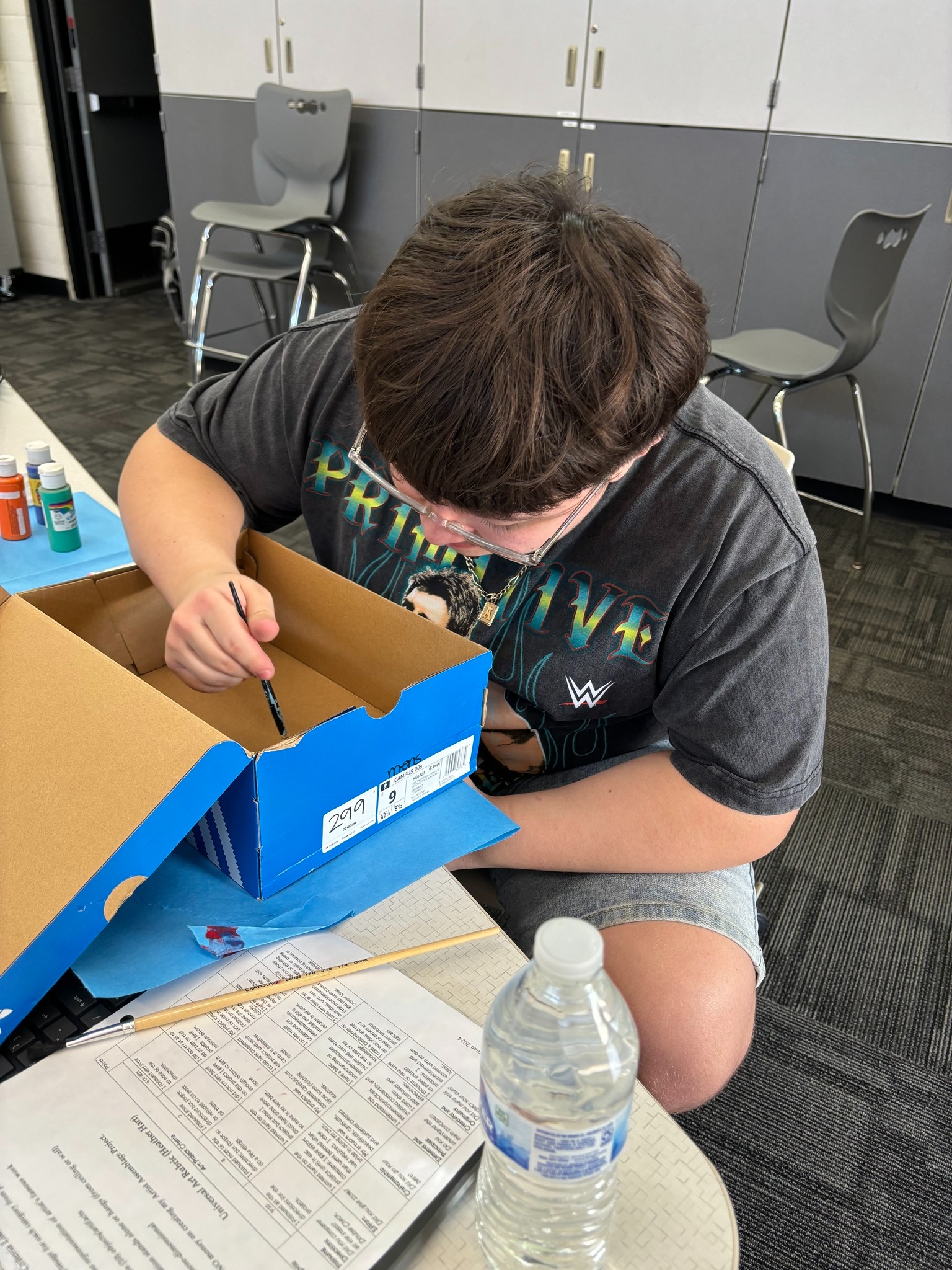 Student painting a box