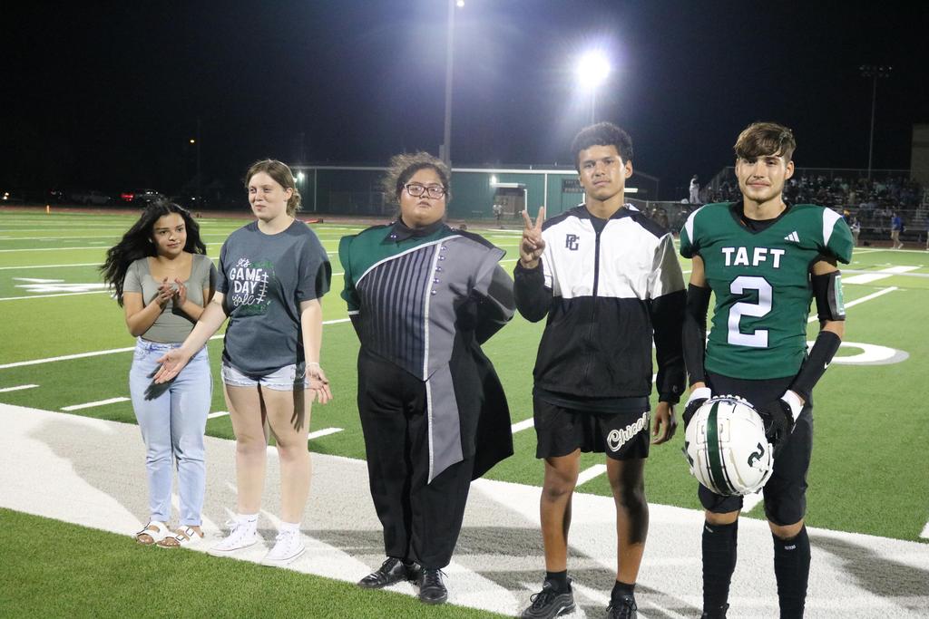 A diverse group of young individuals gathered on a football field, showcasing camaraderie and enthusiasm for the sport.