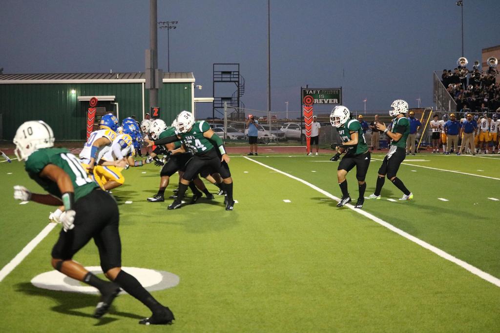 A dynamic football game featuring players actively running and engaging in play on the field.