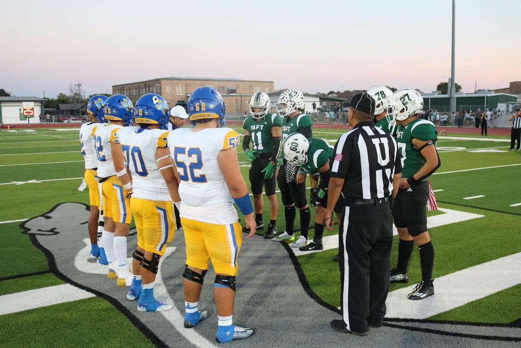 A football team huddled together on the field, strategizing before the next play during a game.